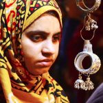 Women are busy selecting and purchasing artificial jewelry from vendor stall in preparation of Eid-ul-Azha at Resham Bazaar
