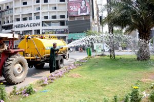 Parks and Horticulture Authority (PHA) workers are busy watering plants along the green belt to maintain the city’s greenery and beautification