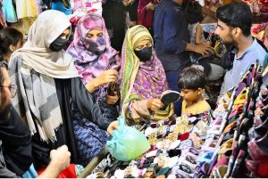 Women are busy selecting and purchasing artificial jewelry from vendor stall in preparation of Eid-ul-Azha at Resham Bazaar