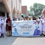 Healthcare staff and nurses participate in a walk to mark International Nurses Day at Allied Hospital-II
