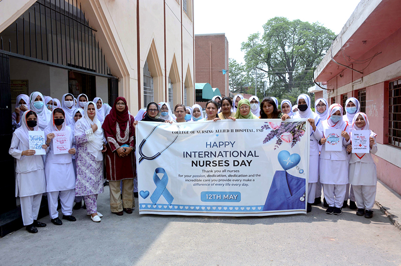 Healthcare staff and nurses participate in a walk to mark International Nurses Day at Allied Hospital-II