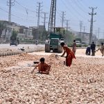 Labourers are busy in road expansion work during an ongoing development project being carried out by the district government at Autobahn Road