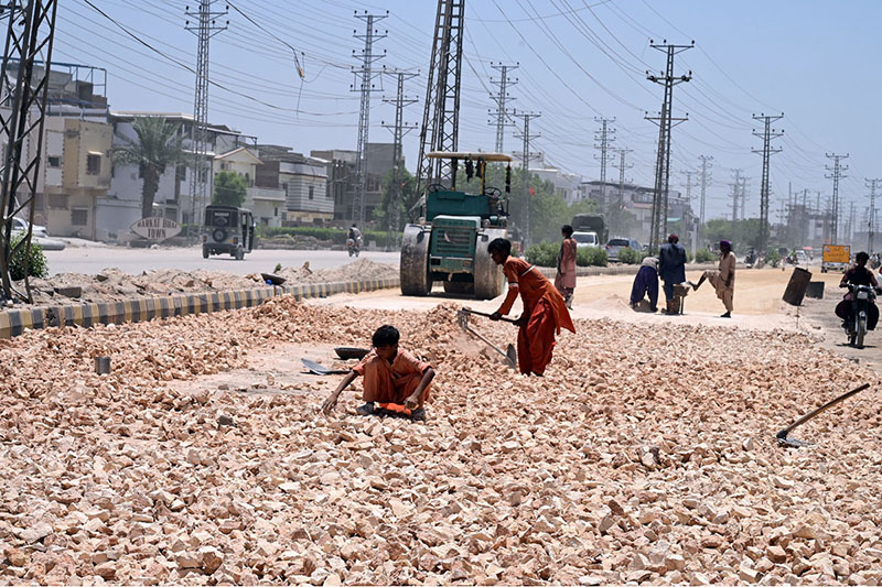 Labourers are busy in road expansion work during an ongoing development project being carried out by the district government at Autobahn Road