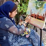 A female artist gives final touches to her artwork during the painting and calligraphy competition jointly organized by the Knowledge of Art Academy and the Walled City of Lahore Authority (WCLA) at historic Masjid Wazir Khan Square