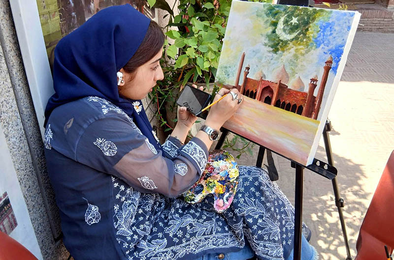 A female artist gives final touches to her artwork during the painting and calligraphy competition jointly organized by the Knowledge of Art Academy and the Walled City of Lahore Authority (WCLA) at historic Masjid Wazir Khan Square