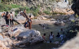 Youngsters enjoy bathing in the water at Shahdara Valley on the outskirts of the Federal Capital.