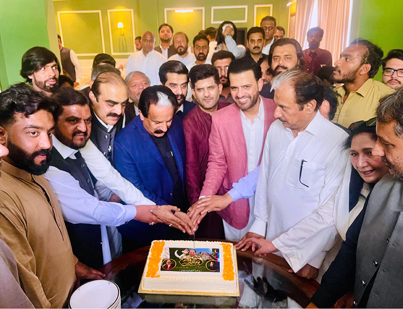 Parliamentary Secretary Barrister Danyal Chaudhry, former Senator Chaudhry Tanvir Khan, and MPA Usama Tanvir Chaudhry cutting the cake to Commemorate Youm-e-Takbir