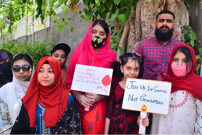 People from different organizations along with children suffering from thalassemia participate in a walk organized by Fatimid Foundation on the eve of World Thalassemia Day at Press Club Road