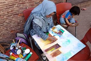 A female artist gives final touches to her artwork during the painting and calligraphy competition jointly organized by the Knowledge of Art Academy and the Walled City of Lahore Authority (WCLA) at historic Masjid Wazir Khan Square