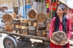A blacksmith is busy sharpening knives and axes to be used for slaughtering sacrificial animals during Eidul Azha