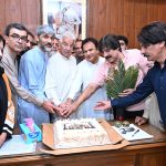 Defense Minister Khawaja Muhammad Asif cutting the Takbeer Day cake with his workers at his liaison office in Cantt