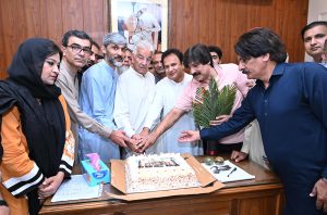 Defense Minister Khawaja Muhammad Asif cutting the Takbeer Day cake with his workers at his liaison office in Cantt. .APP/MUT/ABB