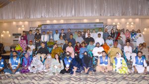Divisional Director Social Welfare Umme Farwa Hamdani poses for a group photo with differently-abled persons during a wheelchair distribution ceremony organized by the Mainstream Association of Disabled Persons