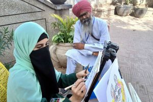 A female artist gives final touches to her artwork during the painting and calligraphy competition jointly organized by the Knowledge of Art Academy and the Walled City of Lahore Authority (WCLA) at historic Masjid Wazir Khan Square