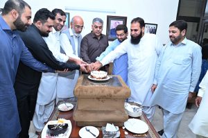 Defense Minister Khawaja Muhammad Asif cutting the Takbeer Day cake with his workers at his liaison office in Cantt. .APP/MUT/ABB