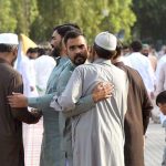 Faithful exchanging Eid greetings with each other after Eidul Azha prayers at Eidgah Sharif