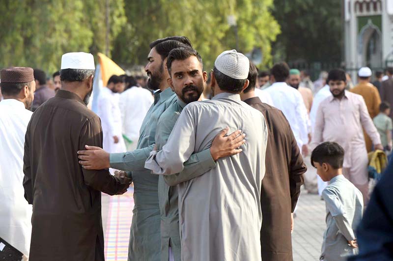 Faithful exchanging Eid greetings with each other after Eidul Azha prayers at Eidgah Sharif