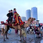 Children enjoy camel ride at sea view during the festivities on the second day of Eidul Azha