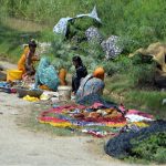 Villager women washing the cloth on roadside at Tando Hyder