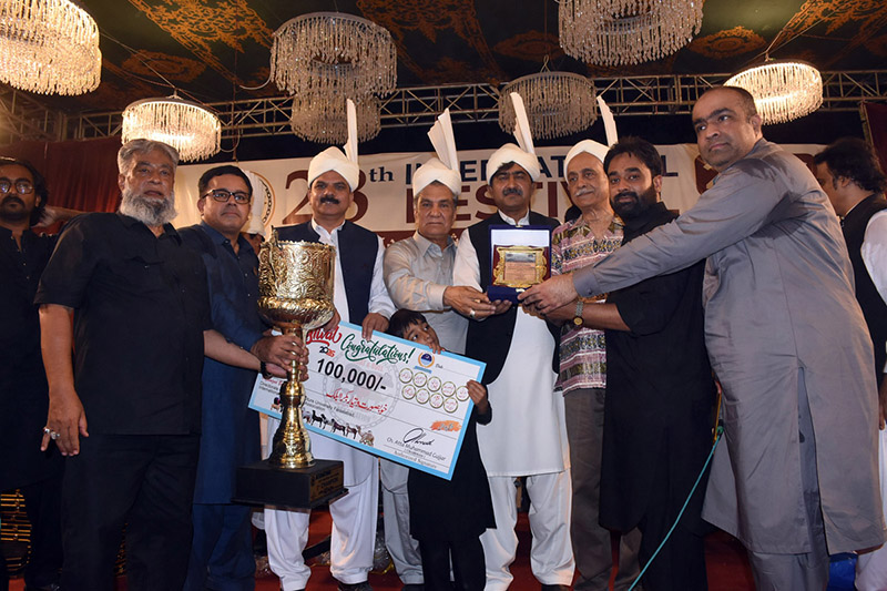 Chairman Punjab Higher Education Commission (PHEC) Prof Dr Iqrar Ahmad Khan along with Vice Chancellor (VC) University of Agriculture Faisalabad (UAF) Prof Dr Zulfiqar Ali is giving away first prize along with trophy to winner of beautiful goat competition during 28th International Festival 2026 at UAF on late Saturday night