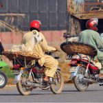 A man transports a goat on a motorcycle as preparations for Eid-ul-Adha continue in the city