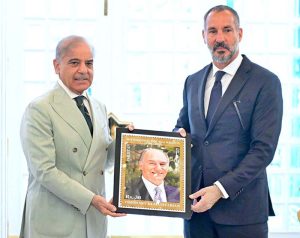 Prime Minister presenting a commemorative stamp to Prince Rahim Agha Khan issued by Pakistan Post to honour His Late Highness Prince Karim Aga Khan IV. for his services to Pakistan.