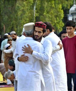 Faithful exchanging Eid greetings with each other after Eidul Azha prayers at Eidgah Sharif