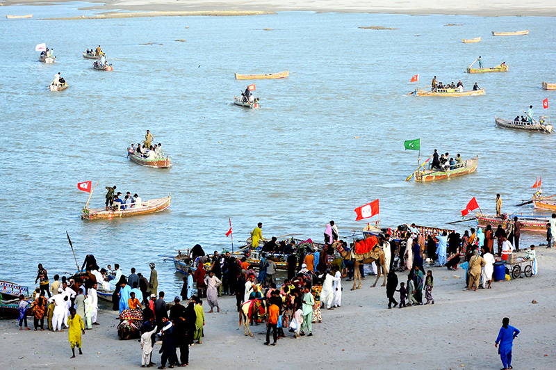 Families enjoying boat rides at the Indus River during the third day of Eid-ul-Azha