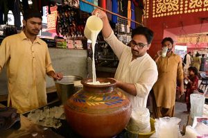 Vendor displaying traditional drink (Lassi) to attract the customer at bacha khan chowk