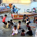 Children bathing in the Indus River to get relief from the heat during the third day of Eid-ul-Azha