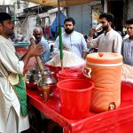 A street vendor sells Sattu, a traditional summer drink mix, from a handcart