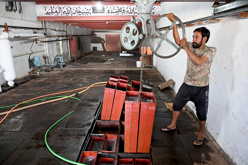 A worker is busy at work in an ice factory as the International Labour Day is observing all over the world