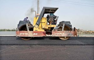 Laborers busy in construction work of Larkana-Ghari Yasin Road during development work.