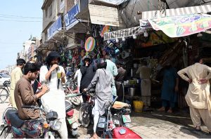 a vendor is selling charcoal grills (angethe) at Muslim Bazaar