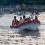 A family enjoys boating at Race Course Park as visitors spend their holiday at the recreational venue