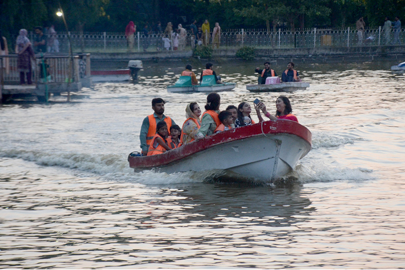A family enjoys boating at Race Course Park as visitors spend their holiday at the recreational venue