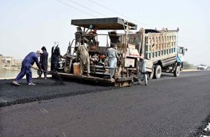 Laborers busy in construction work of Larkana-Ghari Yasin Road during development work.