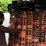 A vendor displays a variety of sunglasses to shield customers from the harsh sun and heat