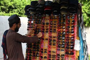 A vendor displays a variety of sunglasses to shield customers from the harsh sun and heat