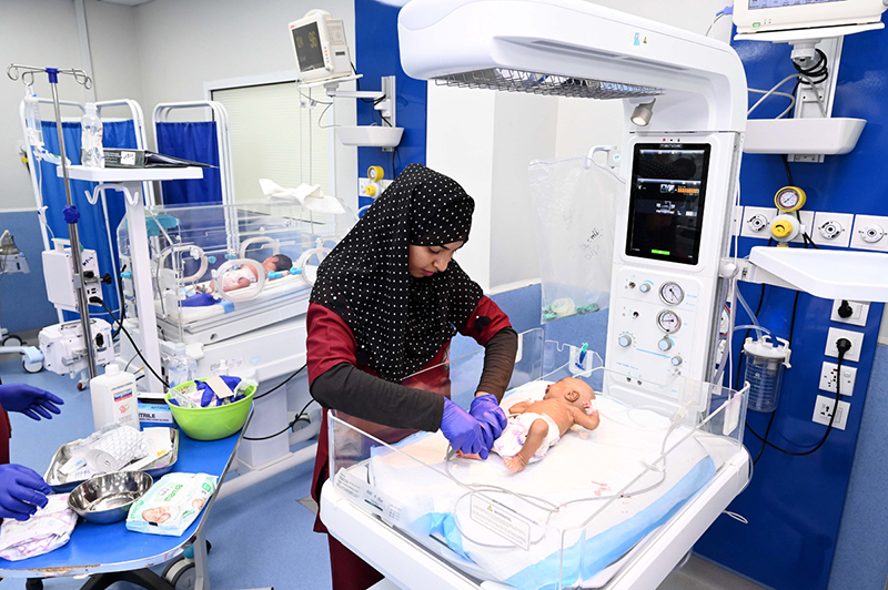 Nursing staff attend to newborn babies in incubators while performing duties on World Nursing Day at Sindh Institute of Child Health and Neonatology (SICHN) Children Hospital