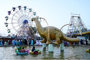 Children enjoy boat ridding and electrical swing on the second day of Eidul Azha at Funland in Rani Bagh