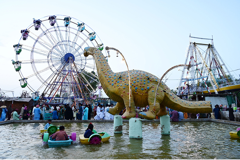 Children enjoy boat ridding and electrical swing on the second day of Eidul Azha at Funland in Rani Bagh