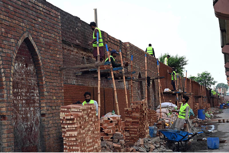Workers are busy renovating and enhancing the wall along the railway station track, adding to the area’s overall appearance