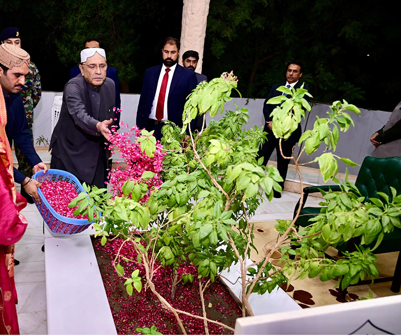 President Asif Ali Zardari offering Fateha and laying flowers on the grave of his mother, Begum Bilqees Sultana, at Baloo Ja Quba accompanied by his sister Fauzia Iqbal