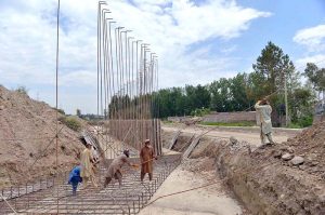 Laborers are busy construction work of Northern Bypass at Warsak Road.