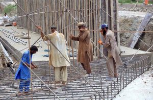 Laborers are busy construction work of Northern Bypass at Warsak Road.