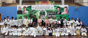 A Group photo of District Sports officer, Saima Manzoor with players during a karate competition held in connection with marking the completion of one year of the victory of Marka-e-Haq Bunyan-ul-Marsoos organized by District Sports department at Sports Gymnasium