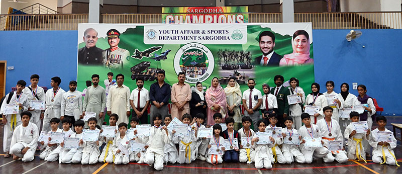 A Group photo of District Sports officer, Saima Manzoor with players during a karate competition held in connection with marking the completion of one year of the victory of Marka-e-Haq Bunyan-ul-Marsoos organized by District Sports department at Sports Gymnasium