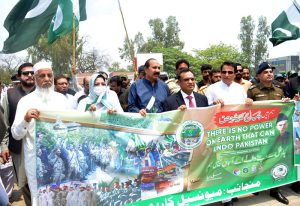 Commissioner Sargodha Hafiz Shoukat Ali leads a rally marking the completion of one year of the victory of Marka-e-Haq Bunyan-ul-Marsoos at Arts Council