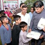 Assistant Commissioner Larkana Raja Khan Qureshi distributing Eid clothes among the Pakistan Baitul Mal's Sweet Home children